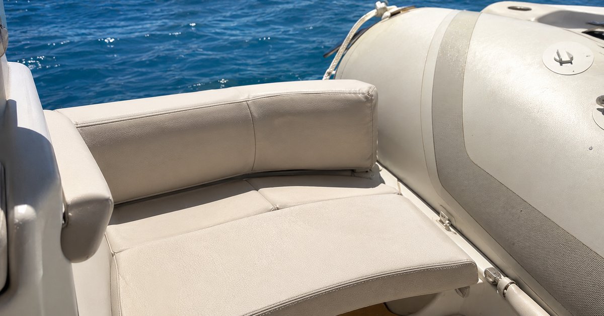 Cuscini e sedute di un gommone in tessuto tecnico nautico chiaro sotto il sole, dettaglio delle cuciture